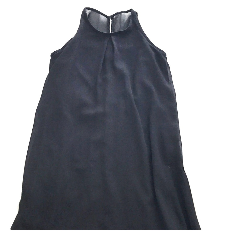 Black shift dress with sheer overlay.